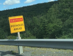 A sign on the side of the road that reads 